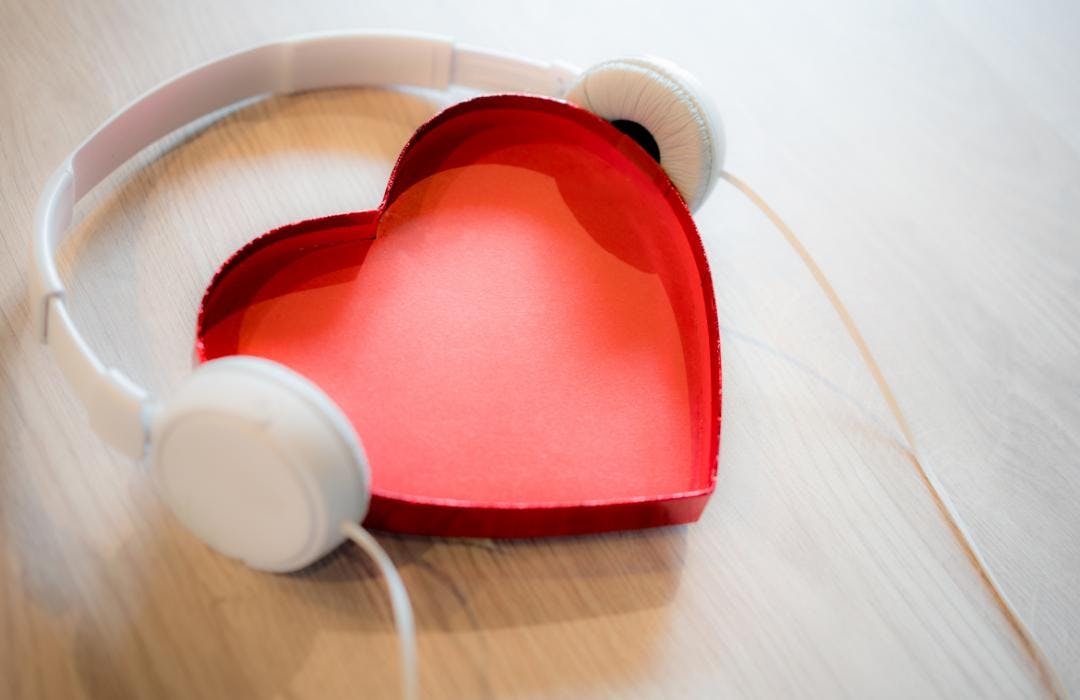 A stylized heart with headphones on
